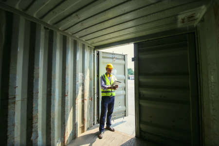 Logistics engineer control at the port, loading containers for trucks export and importing logistic...