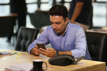 man texting on mobile phone in cafÃ©.の写真素材
