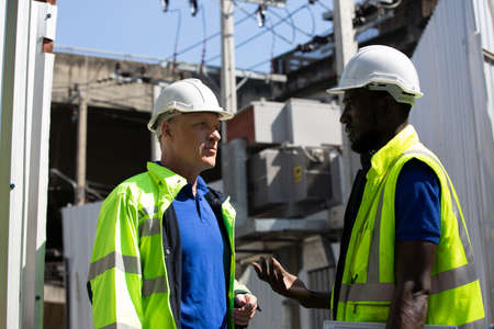 Construction engineers discussion with architects at construction site or building site of high-rise buildingの写真素材