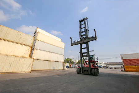 Engineer or supervisor checking and control loading Containers box from Cargo at harbor.Foreman...