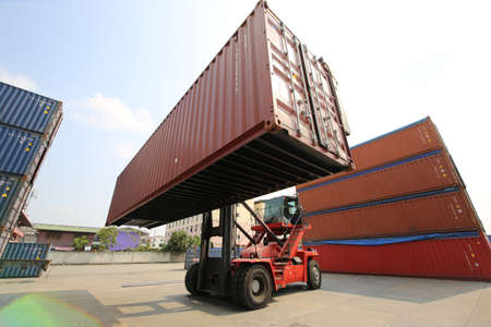 Foreman control loading Containers box from Cargo freight ship for import export. Container...