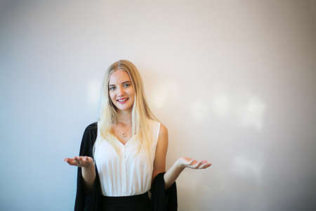 portrait of a beautiful fashion girl with blonde hair posed indoor.