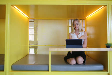 Smiling woman using laptop in work place for small businesses looking to engage audiences and scale...