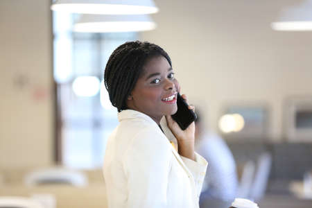 Portrait of a young African girl working at a laptop in a cafe during a coffee break. A break, relax