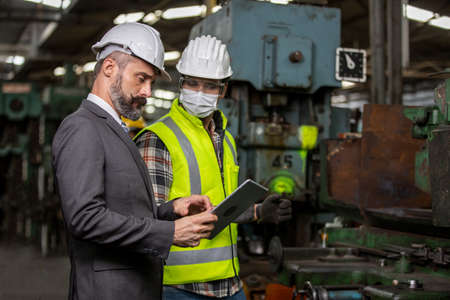 Engineer manager and Factory Workers Team checking machine in production line. Teamwork concept.の写真素材