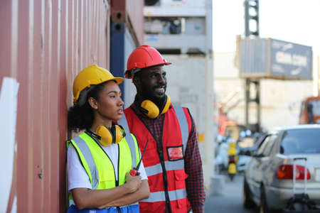 Foreman control loading Containers box from Cargo freight ship for import export. Freight containers in sea port.の写真素材