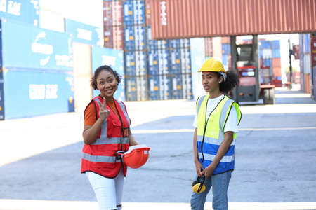 Foreman control loading Containers box from Cargo freight ship for import export. Freight containers...