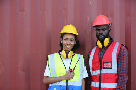 Foreman control loading Containers box from Cargo freight ship for import export. Freight containers...
