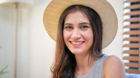 smiling young woman using laptop against Christmas tree.の写真素材