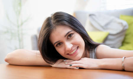 smiling young woman using laptop against Christmas tree.