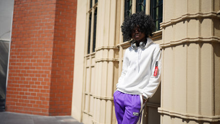 Portrait of young attractive stylish african american man model posing in casual clothes against...