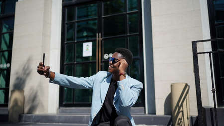 Portrait of young attractive stylish african american man model posing in casual clothes against neutral background looking sexy with afro hair. In People Youth Beauty and fashion concept.の写真素材