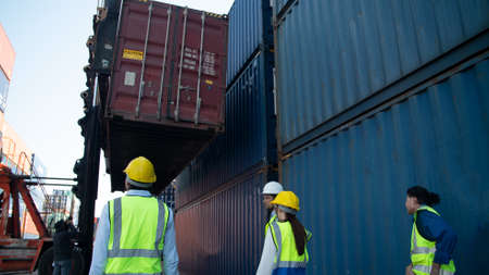 Crane lifting up container in yard