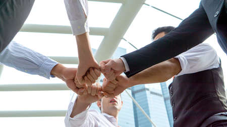 Business people join hands together in a circle. Teamwork concept.の写真素材