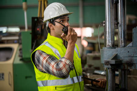 Industrial Engineers in Hard Hats.Work at the Heavy Industry Manufacturing Factory.industrial worker indoors in factory.aged man working in an industrialの写真素材