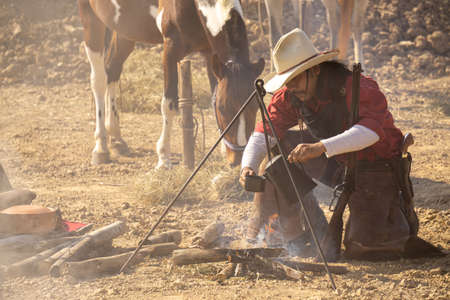 Cowboy preparing horse for a rodeo in the countryside of Brazilの写真素材