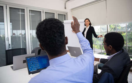 United coworkers standing with their hands together in modern office, celebrating victory, teambuilding and unityの写真素材