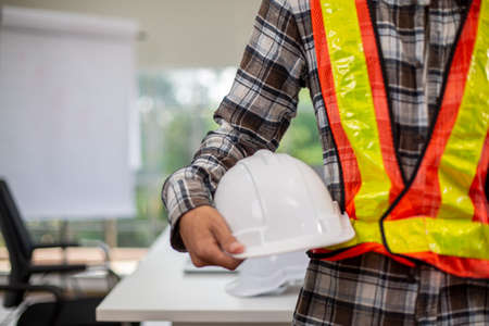 United coworkers standing with their hands together in modern office, celebrating victory, teambuilding and unityの写真素材