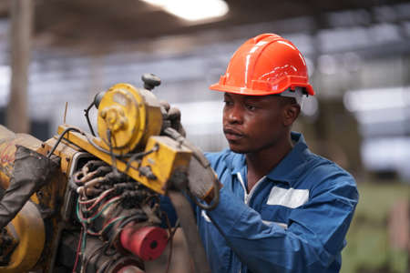 Portrait of Professional Heavy Industry Engineer / Worker Wearing Safety Uniform, Goggles and Hard...