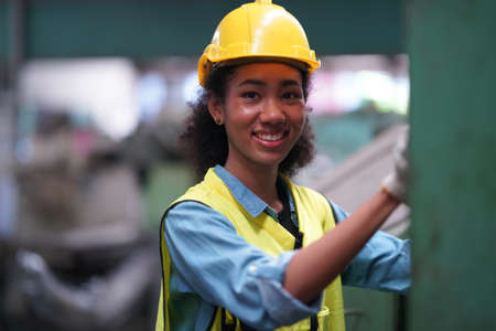 Female apprentice in metal working factory, Portrait of working female industry technical worker or...