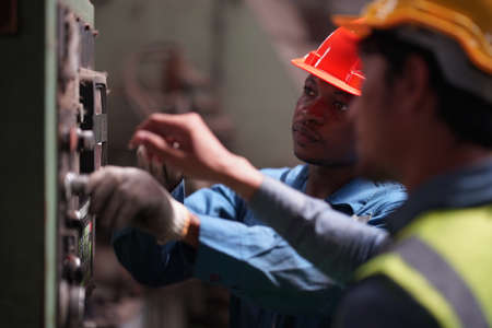 Portrait of Professional Heavy Industry Engineer / Worker Wearing Safety Uniform, Goggles and Hard...