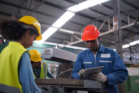 Female apprentice in metal working factory, Portrait of working female industry technical worker or...