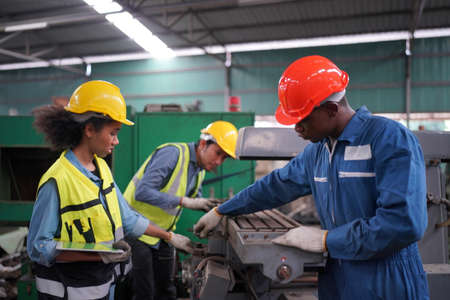 Female apprentice in metal working factory, Portrait of working female industry technical worker or...