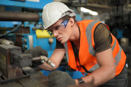 Factory Female Industrial Engineer Works in metal working factory, Inside the Heavy Industry....