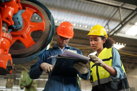 Portrait of Professional Heavy Industry Engineer / Worker Wearing Safety Uniform, Goggles and Hard...