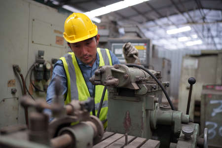 Male engineer metalworker industrial experienced operator technician worker in safety hard helmet...