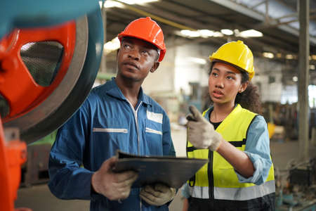 Portrait of Professional Heavy Industry Engineer / Worker Wearing Safety Uniform, Goggles and Hard...