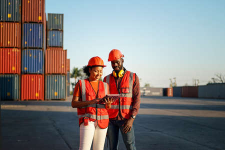 Foreman control loading Containers box from Cargo freight ship for import export.の写真素材