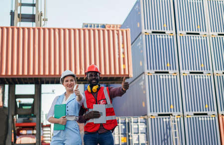 Foreman control loading Containers box from Cargo freight ship for import export.