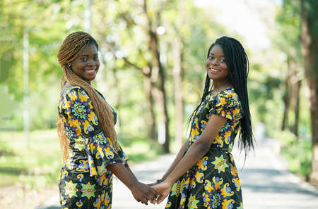 Best friends embracing, couple Afro girl smailing.の写真素材