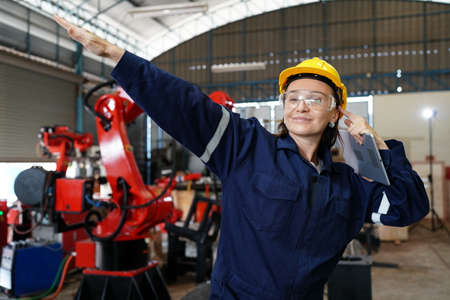 Professional young industrial factory woman employee working with machine parts putting, checking...