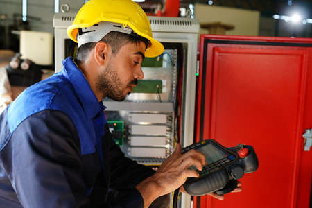 engineer checking control panel and teaching new Automatics robot arm and operating control machine...