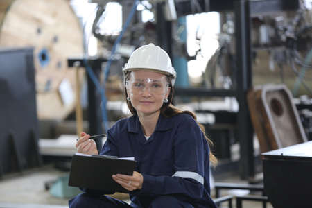 engineer checking control panel and teaching new Automatics robot arm and operating control machine in factory.の写真素材