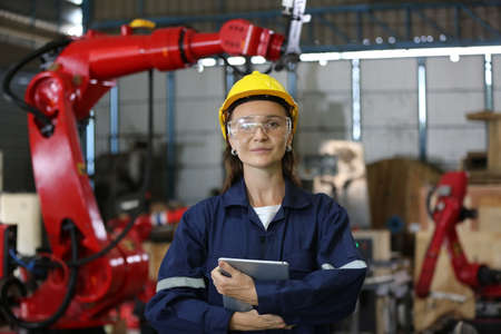engineer checking control panel and teaching new Automatics robot arm and operating control machine...