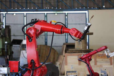 Robotics arm in the metal factory plant . it's performing routine servicing of the welding robotics...