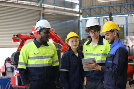 engineer checking control panel and teaching new Automatics robot arm and operating control machine in factory.の写真素材