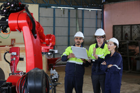 engineer checking control panel and teaching new Automatics robot arm and operating control machine...