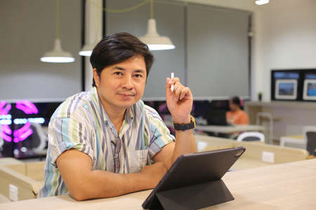 Portrait of male freelancer while working remotely at modern laptop computer connected to wireless...