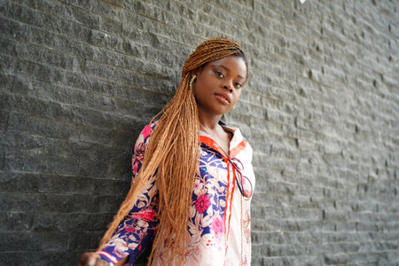 Fashionable Woman with Afro Curly Hairstyle at Streetの写真素材