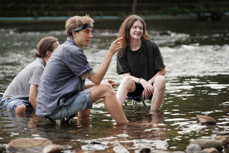 Group of smiling friends hiking with backpacks outdoors. Travel, tourism, hike and people conceptの写真素材