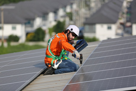 Solar technician working on a photovoltaic panel in a solar power plant