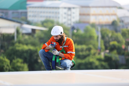 professional technician or engineer installing solar panels, Alternative energy for installed solar panels in use on roof of homeの写真素材