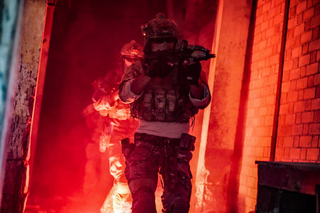 Special forces soldier in action, fire and smoke in abandoned building. Selective focusの写真素材