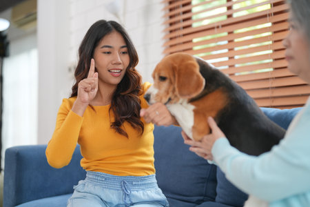 Furry friends. woman resting with dog on sofa at homeの写真素材