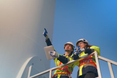 Engineer working at alternative renewable wind energy farm - Sustainable energy industry conceptの写真素材