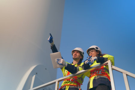 Engineer working at alternative renewable wind energy farm - Sustainable energy industry conceptの写真素材